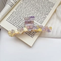 Detail of floral acetate hair claw clip with purple rhinestones on aesthetic book background - Iridescent Yellow / 11cm