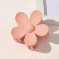 Detail of a matte peach pink flower hair claw clip with frosted texture and spring design - Snow Bud