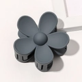 Detailed macro view of gray flower hair claw clip with a matte frosted finish on white surface - Blue Grey
