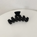 Detail shot of a large matte black hair claw clip with a unique geometric zigzag design - Black