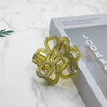 Detailed macro shot of an olive green flower hair claw clip with marble texture on props - 7cm / Fruit Green