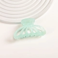 Close-up of light mint green acetate pumpkin hair claw clip on a white display tray - Mint Green