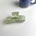 Macro shot of green marble acetate hair claw clip showing texture and detailed grip teeth - About 9cm / Green