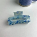 Detailed macro view of a rectangular marble acetate hair claw clip on white background - About 9cm / Blue