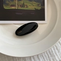 Detail of a black oval hair clip with gold France Handmade lettering on a porcelain plate - Black