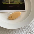 Detailed close-up of cream yellow oval hair clip featuring France Handmade engraved text - Yellow