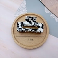 Close-up of 7.5cm black and white marble acetate hair claw clip showing fine texture - Medium Square