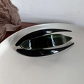 Detailed view of a green acetate hair claw clip on a minimalist beige display plate - Jungle Pattern