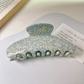 Detailed macro view of the acetate hair claw clip featuring a blue and white mottled pattern - Blue Spotted Style