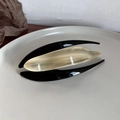 Detailed view of large acetate hair claw with beige marble pattern on ceramic plate - Beige Plaid