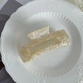 Detail of a large cream marble acetate hair claw clip on a white ceramic plate - 10cm / Milk Tea