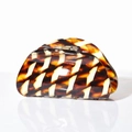 Close-up of a large tortoiseshell acetate hair claw clip with golden metal spring - 8cm / Caramel color