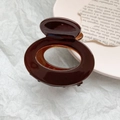 Elegant large coffee brown hollow hair claw clip with glossy resin finish for women - 6cm Round Style