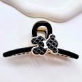 Dettaglio della molletta per capelli a forma di orso nero in acetato con fiocco bianco - Nero