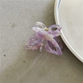 Close-up of a purple marble acetate butterfly hair claw clip with golden metal spring - Purple