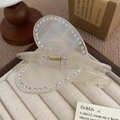 Detail view of large matte heart hair claw clip with sparkling rhinestones and metal spring - Iridescent White Heart / 6.8cm