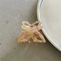 Detailed macro view of a pink butterfly hair claw with marble texture and metal spring - Rice Pink