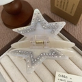Detailed view of pentagram star hair claw clip with rhinestones on beige tray - White Star (A3-4-18) / 9.2cm