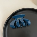 Close-up of a small vintage acetate hair claw clip in dark blue with golden text - Blue (6CM)