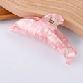 Detailed macro view of dolphin-shaped hair claw clip with pink marble texture finish - Pink Marble Pattern