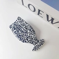 Detail view of acetate hair claw clip with black and white terrazzo marble pattern - Spotted Black