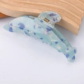 Detail view of dolphin-shaped hair claw with blue marble texture and silver spring - Blue White Marble