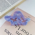 Close-up of a hollow butterfly hair claw in marbled purple and blue acetate material - Purple
