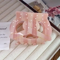Close-up of pink marble acetate hair claw with white polka dots and gold glitter stripes - Large (8cm) / Pink