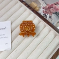 Detail of amber acetate hair claw with white polka dots and gold accents on a tray - Small (3.5cm) / Caramel color