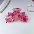 Detail view of the pink marble textured acetate butterfly hair claw clip for women - 9.5CM / Red