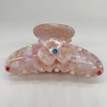Close-up of pink marble acetate hair claw with floral rhinestone and crystal accents - One Small Flower (A11-2-35) / Small Flower