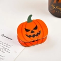 Close-up of a pumpkin-shaped Halloween hair claw clip with a black Jack-o'-lantern face - Style 3 Pumpkin Claw (5081000761734)