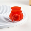 Detailed view of a vibrant red rose hair claw clip on a textured white display stand - 4.5CM / Red