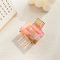 Detailed macro view of a rectangular hollow acetate hair claw with pink and orange marble texture - 3.5cm / Metallic Red