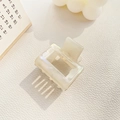Detail of a square pearl acetate hair claw clip with a hollow design on white leather - Small / Mermaid White