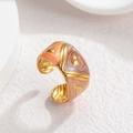 Detail of gold enamel ring with orange and pink marble textures and golden triangles - Orange Pink Marble