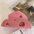 Close-up of pink cheese-shaped hair claw clip with hollow triangular Swiss cheese texture - 9.4cm / Rose Pink