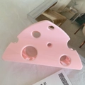 Close-up of pink cheese-shaped hair claw clip with hollow triangular cutouts - 9.4cm / Pink