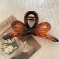 Detail of amber tortoiseshell bow hair claw clip on white fleece background texture - Tortoiseshell-Approx 12.5cm