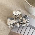 Detail of a small acetate bow hair claw clip with black and white marble pattern texture - 4cm / Off-White