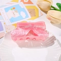 Close-up of pink marble acrylic hair claw clip with bow shape and silver spring mechanism - Bowknot Style (8.7cm)