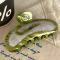 Detailed close-up of a green acetate hair claw clip with marble texture and snake design - Forest Green Snake