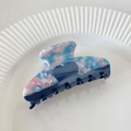 Close-up of heart acetate hair claw with marble texture on a white ceramic plate - Blue Heart