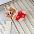 Detail of Christmas claw clip with Corgi dog in festive red sock on velvet box - Corgi in Christmas Sock