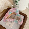 Detail of pink and mint heart-shaped acetate hair claw clip on rustic wooden tray - 7.2cm / Floral Pink