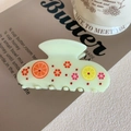 Detail of light green acetic acid hair claw with orange patterns and small rhinestones - Grapefruit Pattern 8cm