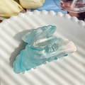 Light blue marble acetate hair claw clip with pearlescent finish on a white plate - Ocean Blue 8.5cm