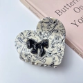 Acetate heart claw clip with black marble texture and a 3D decorative bow accent - Black and White