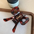 Macro shot of a red and black checkered bow claw clip with a gold metal spring detail - Red Plaid 7cm