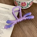 Macro shot of gradient purple bow hair claw clip with a matte finish on vintage books - Gradient Purple 11cm